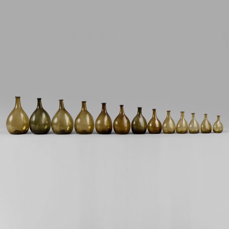 An Exceptional Set of 13 Graduated Blown Chestnut Bottles